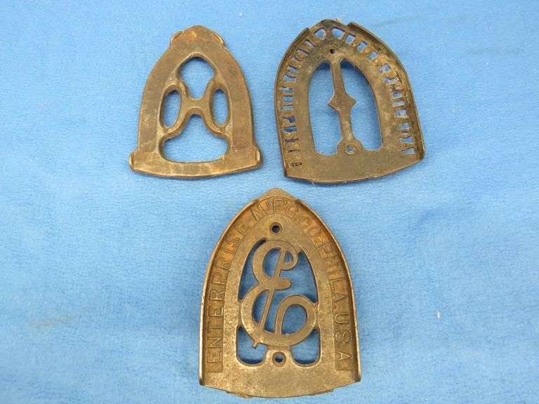 Three cast iron trivets