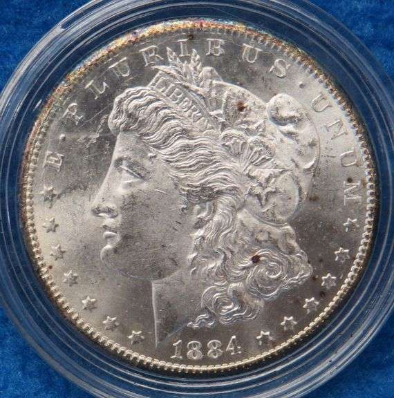 1884 CC Morgan silver dollar in BU condition with a Certificate of Authenticity and display box. Ple