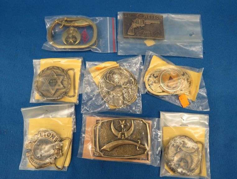Eight belt buckles from fraternal organizations and one from Smith and Wesson. Some are marked as br