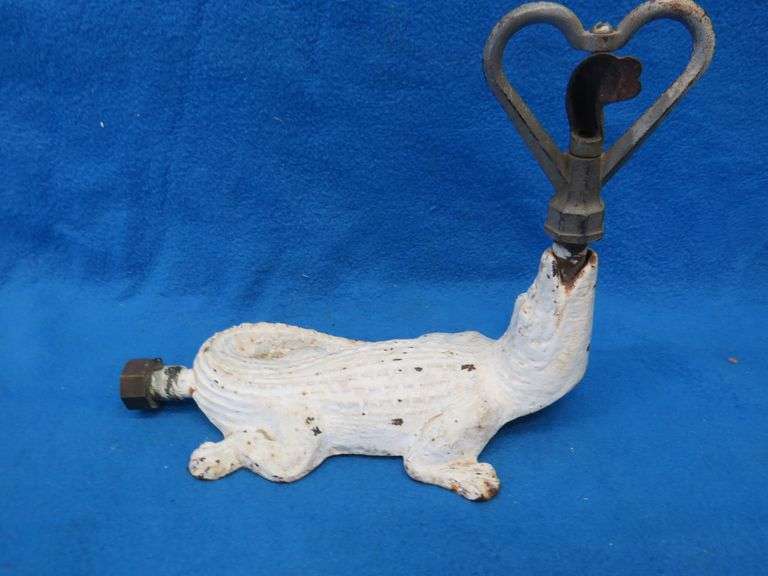 Antique cast iron lawn sprinkler in the form of an alligator.  Unknown maker.