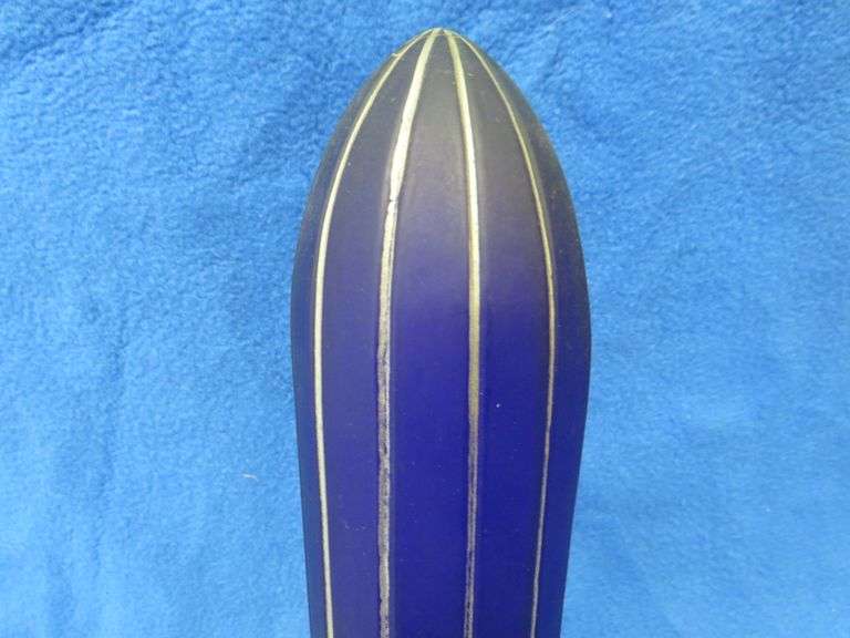 Art Deco era table lamp depicting an airplane in flight.  Cobalt blue glass shade