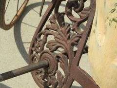 Antique wooden horse tricycle with a cast iron frame, hand-painted details, leather saddle, and wood