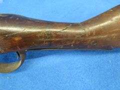 Antique black powder rifle.  Unknown maker or caliber.  Not safe to shoot.  Non-operable hammer and 