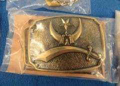 Eight belt buckles from fraternal organizations and one from Smith and Wesson. Some are marked as br