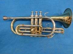 Frank Horton Model C301 cornet. Good used condition.  Valves work good.  Includes two mutes, case, a