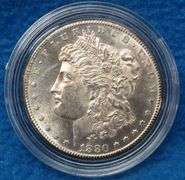 1880 S Morgan silver dollar in BU condition with a a copy of the Certificate of Authenticity