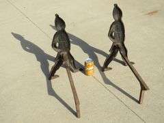 Two matching Hessian soldier antique cast iron andirons