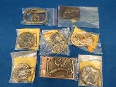 Eight belt buckles from fraternal organizations and one from Smith and Wesson. Some are marked as br