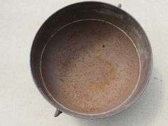 Vintage cast iron kettle 20" wide x 10 1/2" deep, has all three feet and the handle