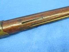 Antique black powder rifle.  Unknown maker or caliber.  Not safe to shoot.  Non-operable hammer and 