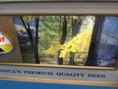 Falstaff American panorama backlit rolling motion sign.  Scenes changes from fall, winter, and summe