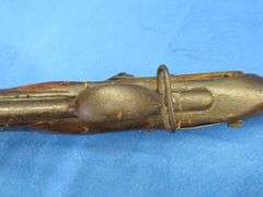 Antique black powder rifle.  Unknown maker or caliber.  Not safe to shoot.  Non-operable hammer and 