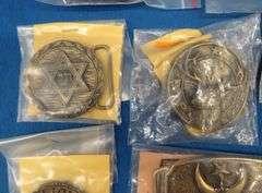 Eight belt buckles from fraternal organizations and one from Smith and Wesson. Some are marked as br
