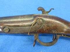 Antique black powder rifle.  Unknown maker or caliber.  Not safe to shoot.  Non-operable hammer and 