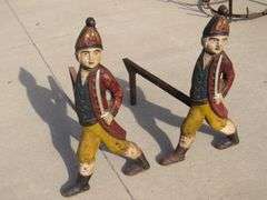Two matching Hessian soldier antique cast iron andirons