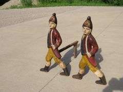 Two matching Hessian soldier antique cast iron andirons