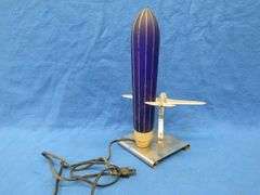 Art Deco era table lamp depicting an airplane in flight.  Cobalt blue glass shade