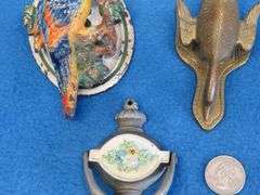Cast iron door knockers and a brass paper clip goose