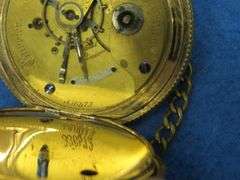 Gold watch with chain and key as described: