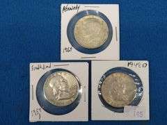 Two Franklin and one Kennedy half-dollars