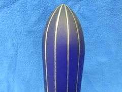 Art Deco era table lamp depicting an airplane in flight.  Cobalt blue glass shade
