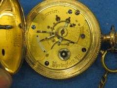 Gold watch with chain and key as described: