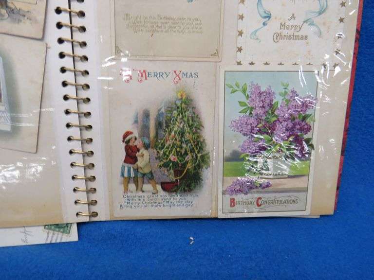 Two scrapbooks filled with postcards, greeting cards. tobacco cards, and more