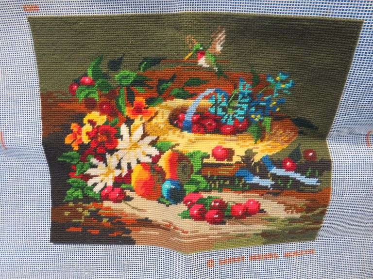 Completed cross stitch and a vintage rubber "Old Ironsides" door stop.
