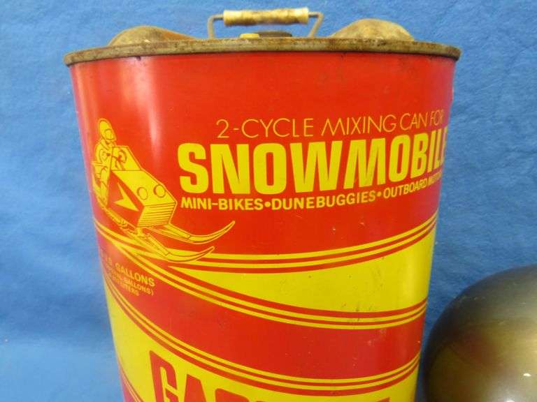 Vintage snowmobile Stancan 6.5 gallon steel gas can and a 6 7/8-7" Bell helmet.