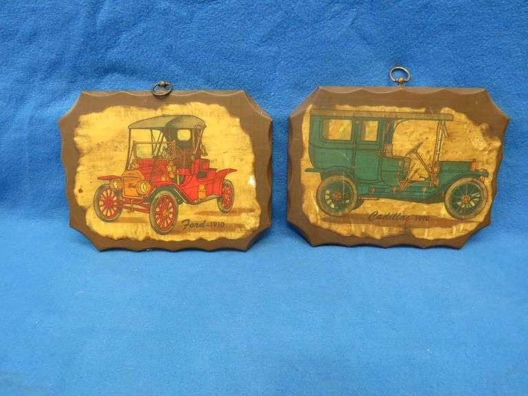 Two wall plaques depicting antique cars