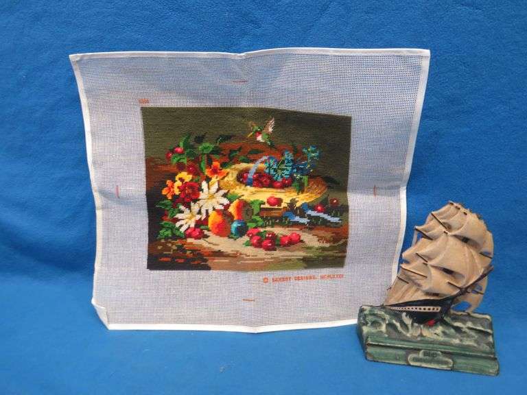 Completed cross stitch and a vintage rubber "Old Ironsides" door stop.