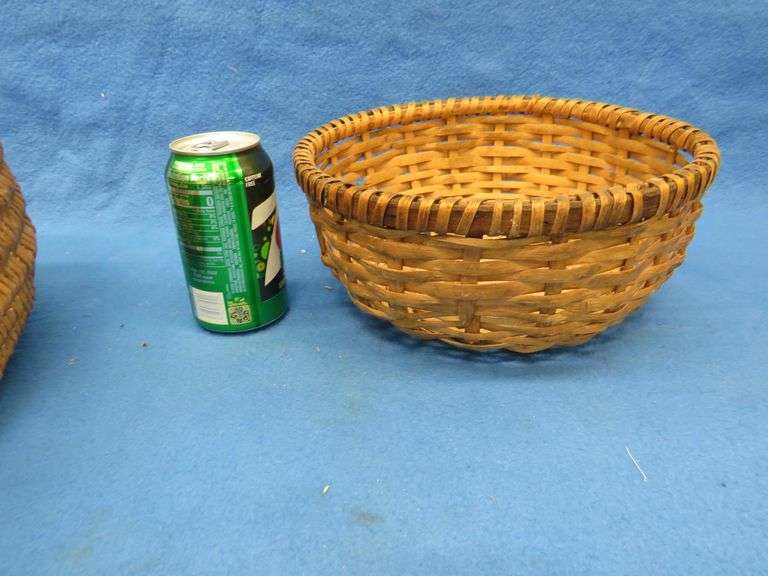 Two wicker baskets, a glass shade, and glass ball fishing floats.