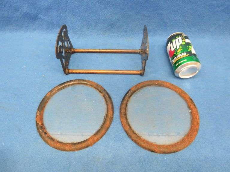 Two 7" round windows in metal frames and an adjustable metal book rack