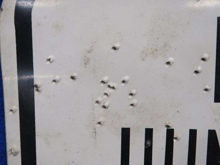 Plastic like No Hunting or Shooting sign that has been hunted
