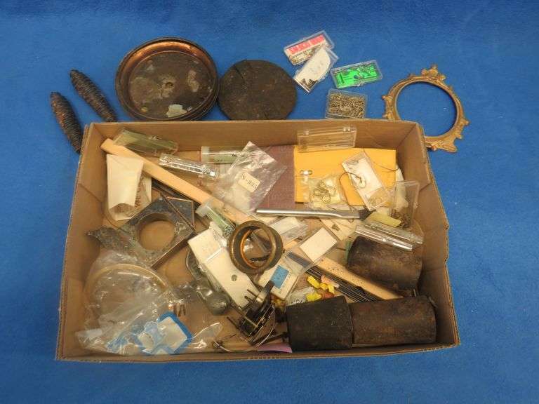 Clock parts including weights, extremely small screws, and more.