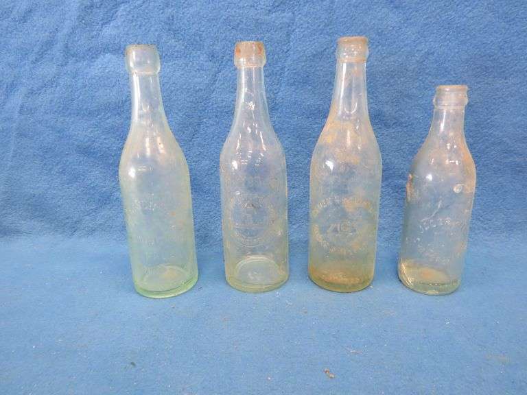 Four old beer bottles from Jac. Schmidt, Gluek, C. Birkhofer, and Jacob Ries