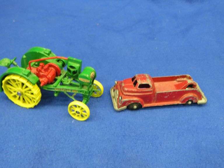 Small-scale die-cast John Deere Waterloo Boy tractor and an old metal tow truck
