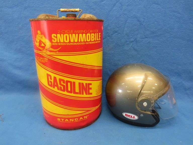 Vintage snowmobile Stancan 6.5 gallon steel gas can and a 6 7/8-7" Bell helmet.