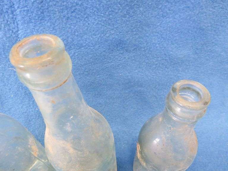 Four old beer bottles from Jac. Schmidt, Gluek, C. Birkhofer, and Jacob Ries