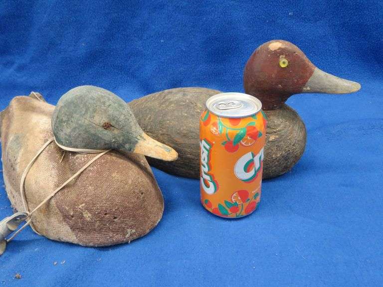Two vintage duck decoys, one cork and one wooden with glass eyes