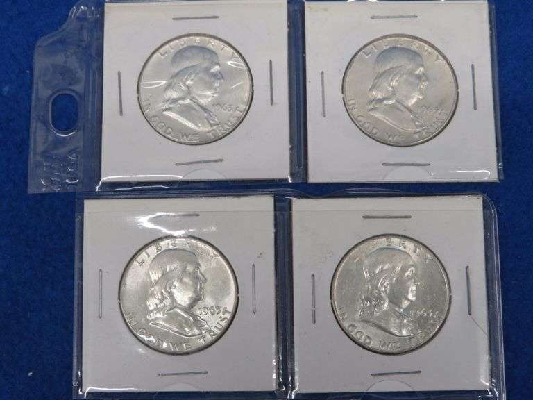 Four Franklin half-dollars