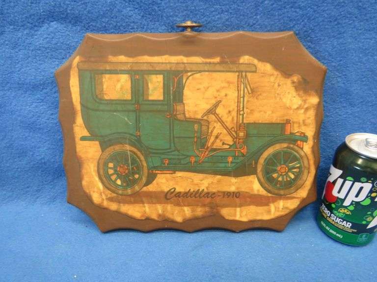 Two wall plaques depicting antique cars