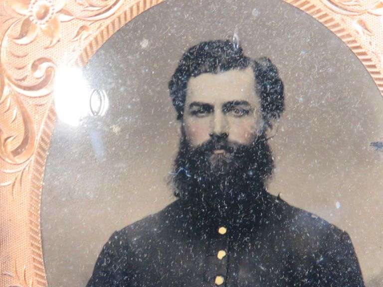 Civil-War-era tintype in a military-themed case.  Very good condition.  Hand-colored photo of a sold
