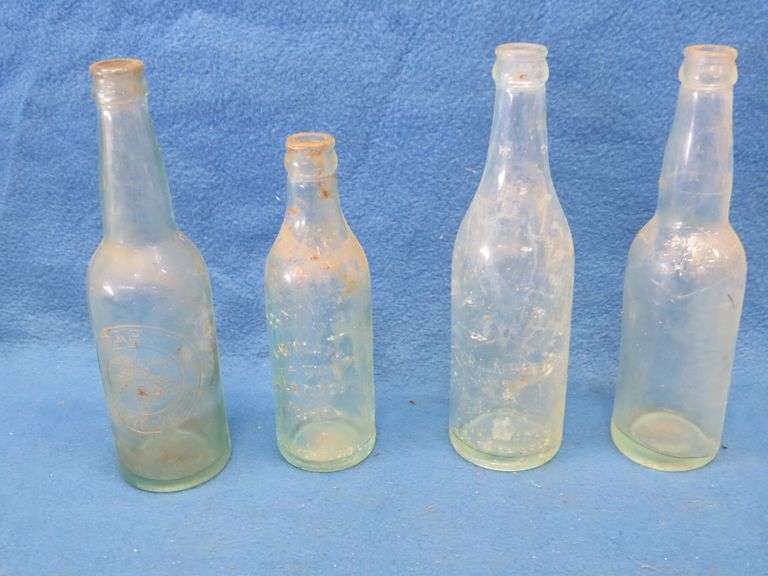 Four old beer bottles from Grain Belt, Pabst, and  J. B. Mayer