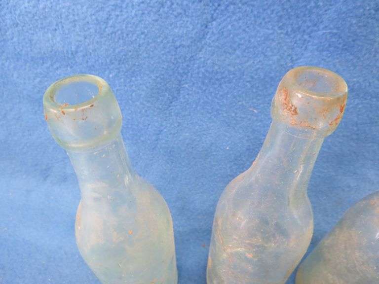 Four old beer bottles from Jac. Schmidt, Gluek, C. Birkhofer, and Jacob Ries