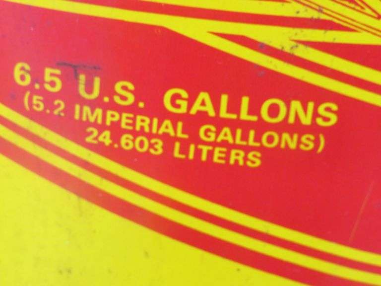 Vintage snowmobile Stancan 6.5 gallon steel gas can and a 6 7/8-7" Bell helmet.