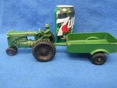 Two toy tractors.  Minneapolis Moline with a trailer and a John Deere.