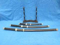 Three-sword set with scabbards and display stand