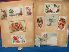 Two scrapbooks filled with postcards, greeting cards. tobacco cards, and more