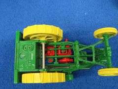 Small-scale die-cast John Deere Waterloo Boy tractor and an old metal tow truck